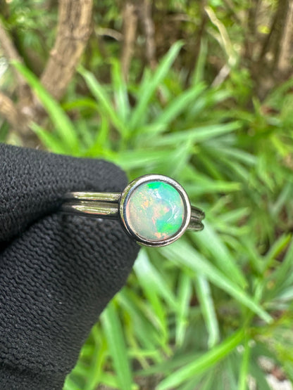 Ethiopian Opal women’s ring showcasing full fire and vibrant rainbow play-of-color, set in elegant sterling silver. October birthstone jewelry symbolizing hope, creativity, and emotional balance — perfect gift for her on any occasion.