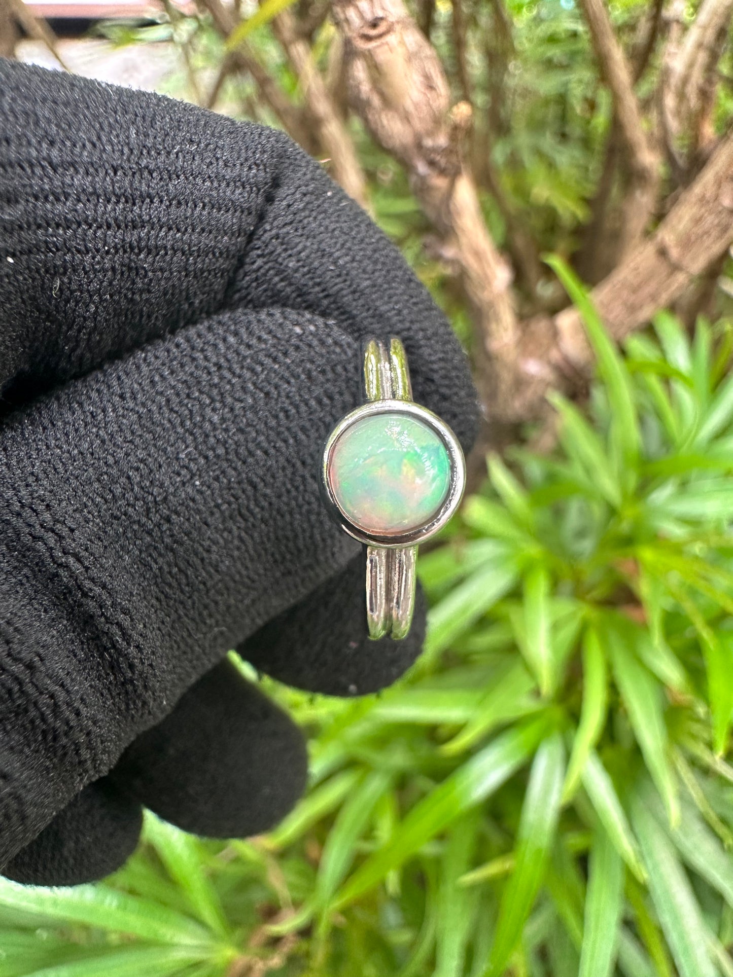 Ethiopian Opal women’s ring showcasing full fire and vibrant rainbow play-of-color, set in elegant sterling silver. October birthstone jewelry symbolizing hope, creativity, and emotional balance — perfect gift for her on any occasion.