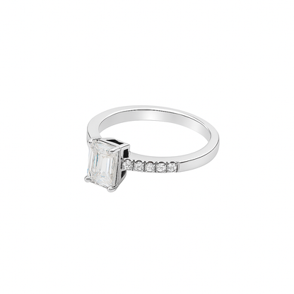 Elegant emerald-cut moissanite engagement ring in 925 sterling silver with pavé-set side stones. Features a brilliant D-color moissanite center stone offering diamond-like sparkle and clarity. Perfect as an engagement or anniversary ring, ethically crafted and ideal for everyday luxury wear