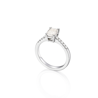 Elegant emerald-cut moissanite engagement ring in 925 sterling silver with pavé-set side stones. Features a brilliant D-color moissanite center stone offering diamond-like sparkle and clarity. Perfect as an engagement or anniversary ring, ethically crafted and ideal for everyday luxury wear