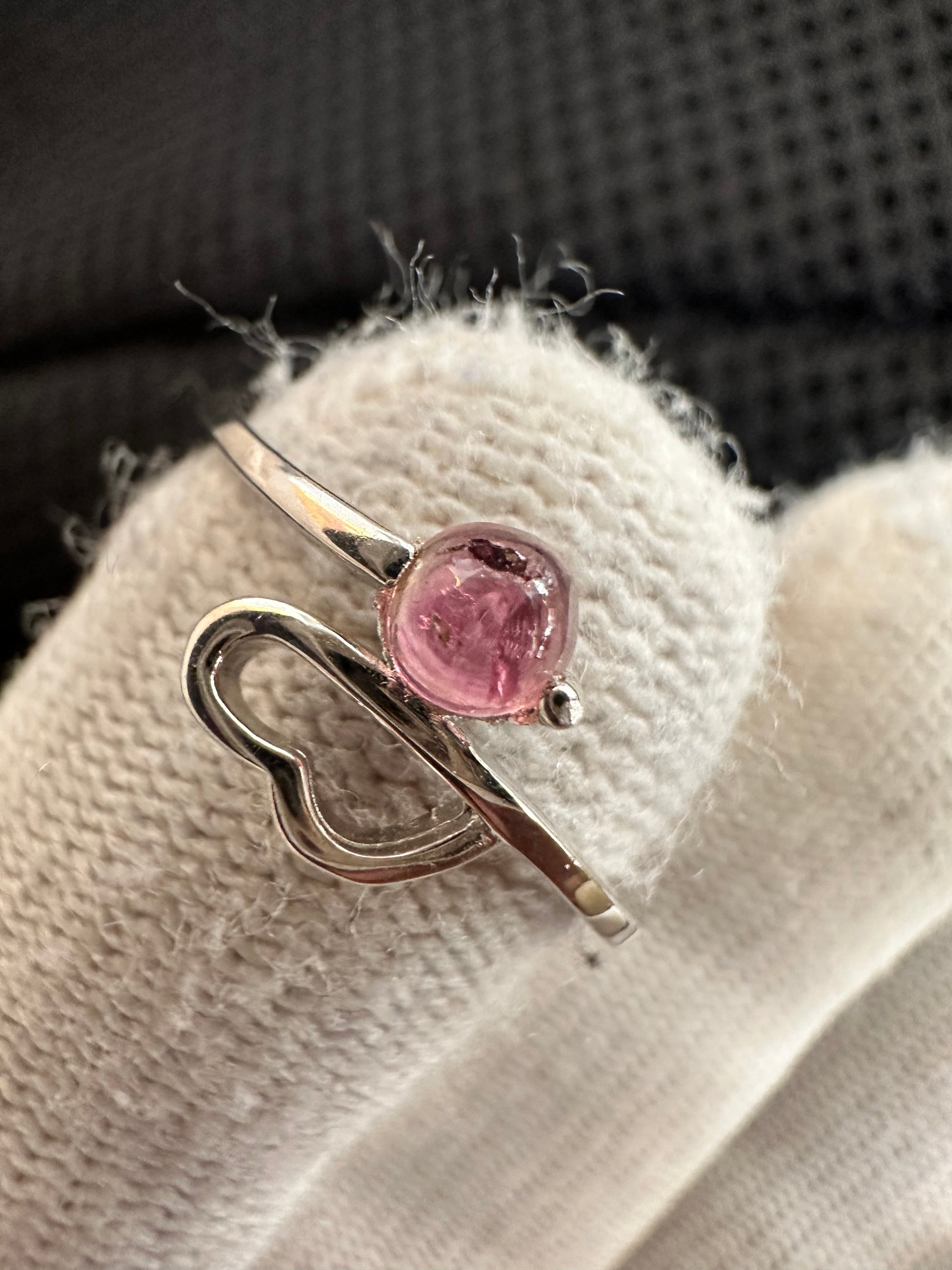 Silver ring with an oval-cut pink tourmaline gemstone , featuring a polished band with intricate detailing