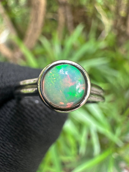 Ethiopian Opal women’s ring showcasing full fire and vibrant rainbow play-of-color, set in elegant sterling silver. October birthstone jewelry symbolizing hope, creativity, and emotional balance — perfect gift for her on any occasion.